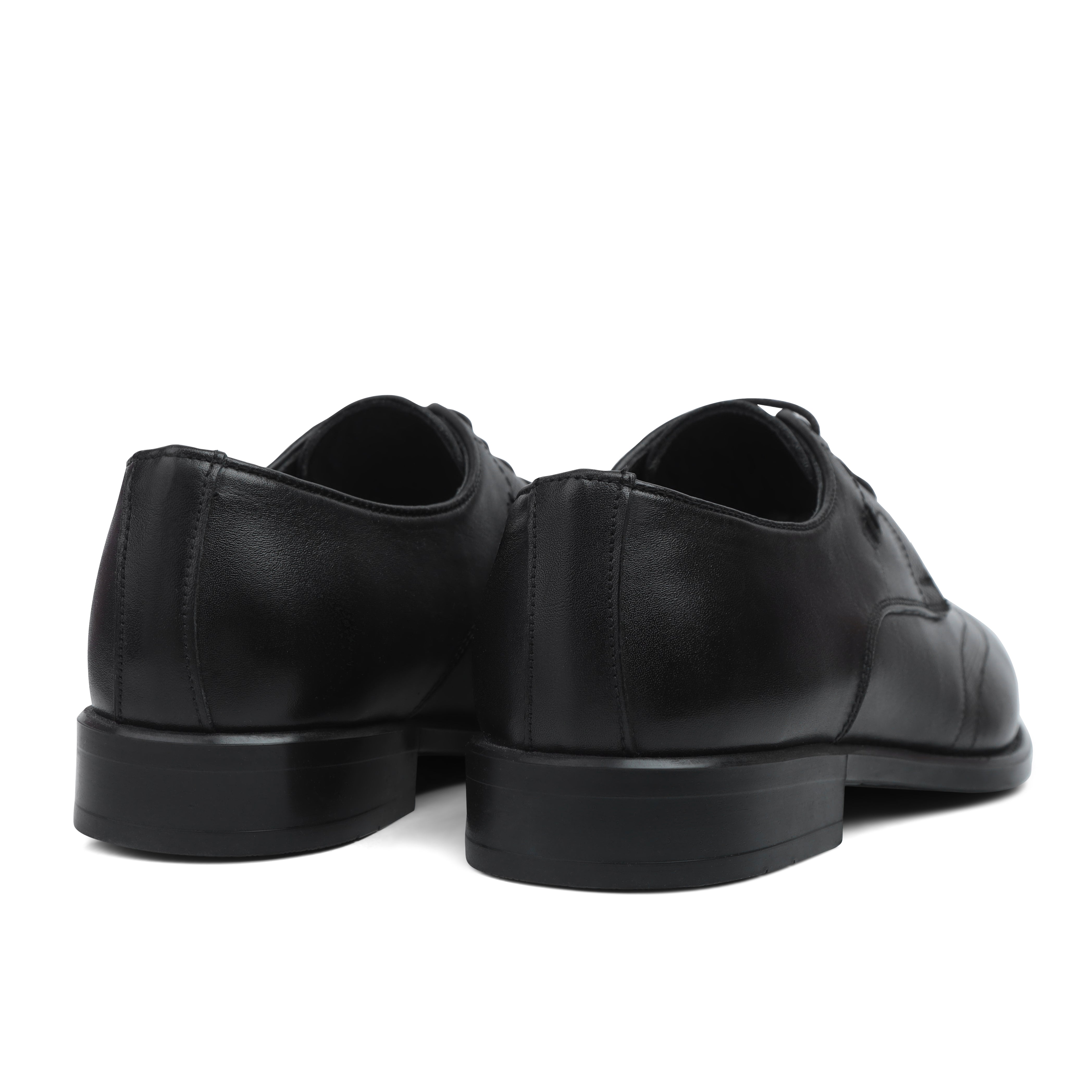 Image of Black leather dress shoes on a white background
