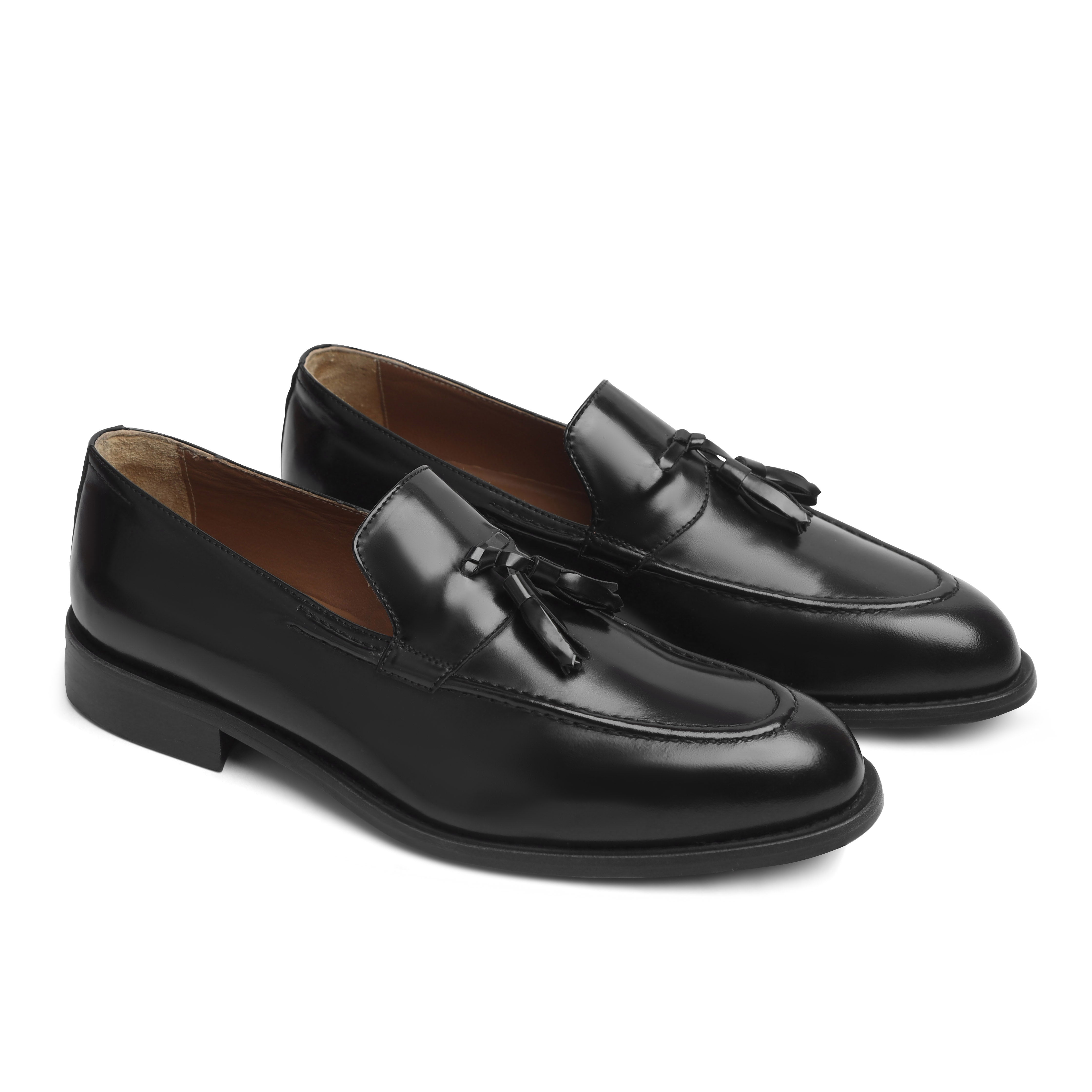 Image of Pair of black loafers with tassels on a white background