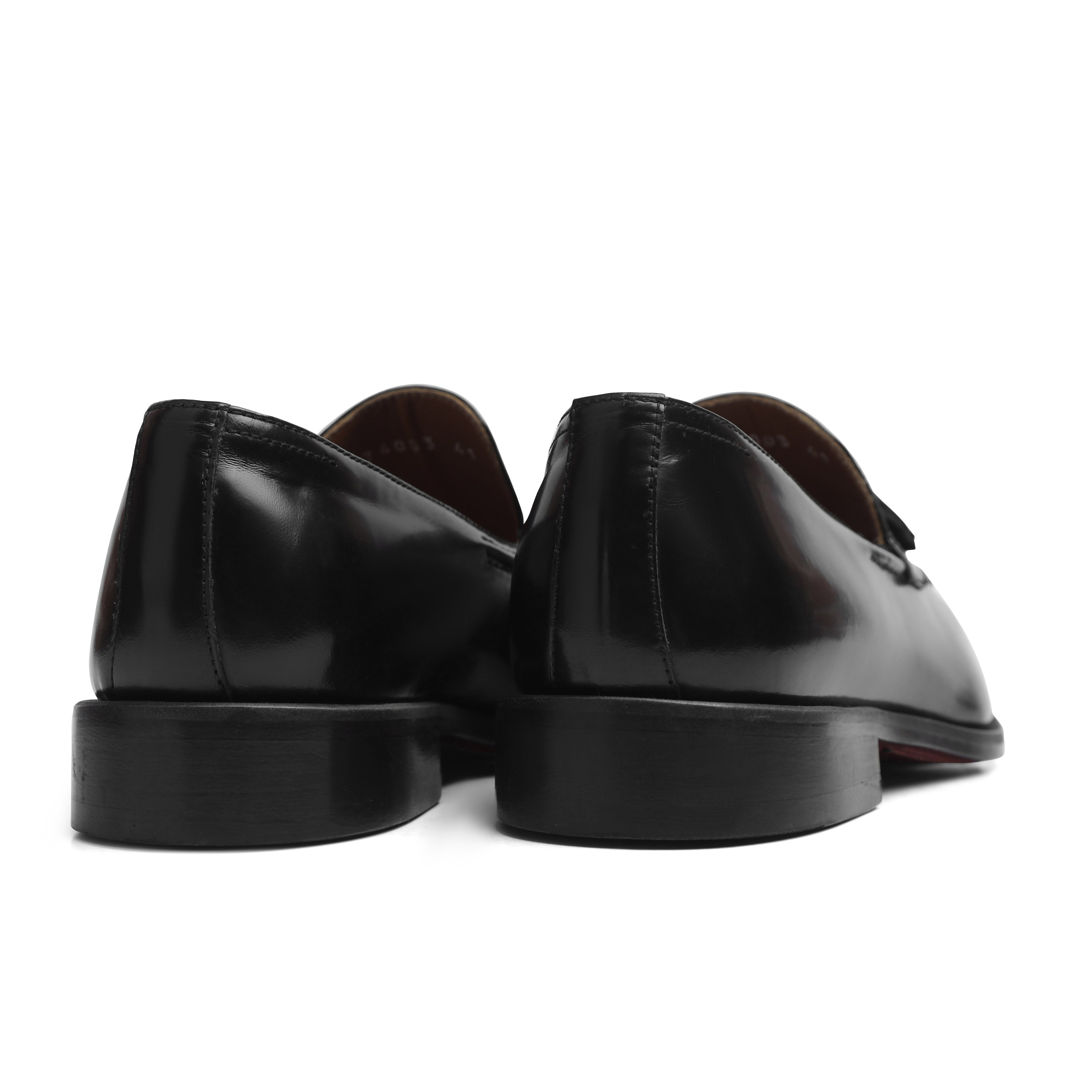 Image of Pair of black leather loafers on a white background
