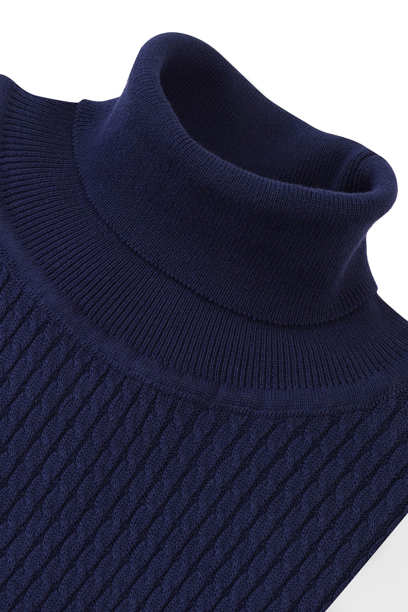 Image of Close-up of a navy blue sweater with a ribbed texture on a white background