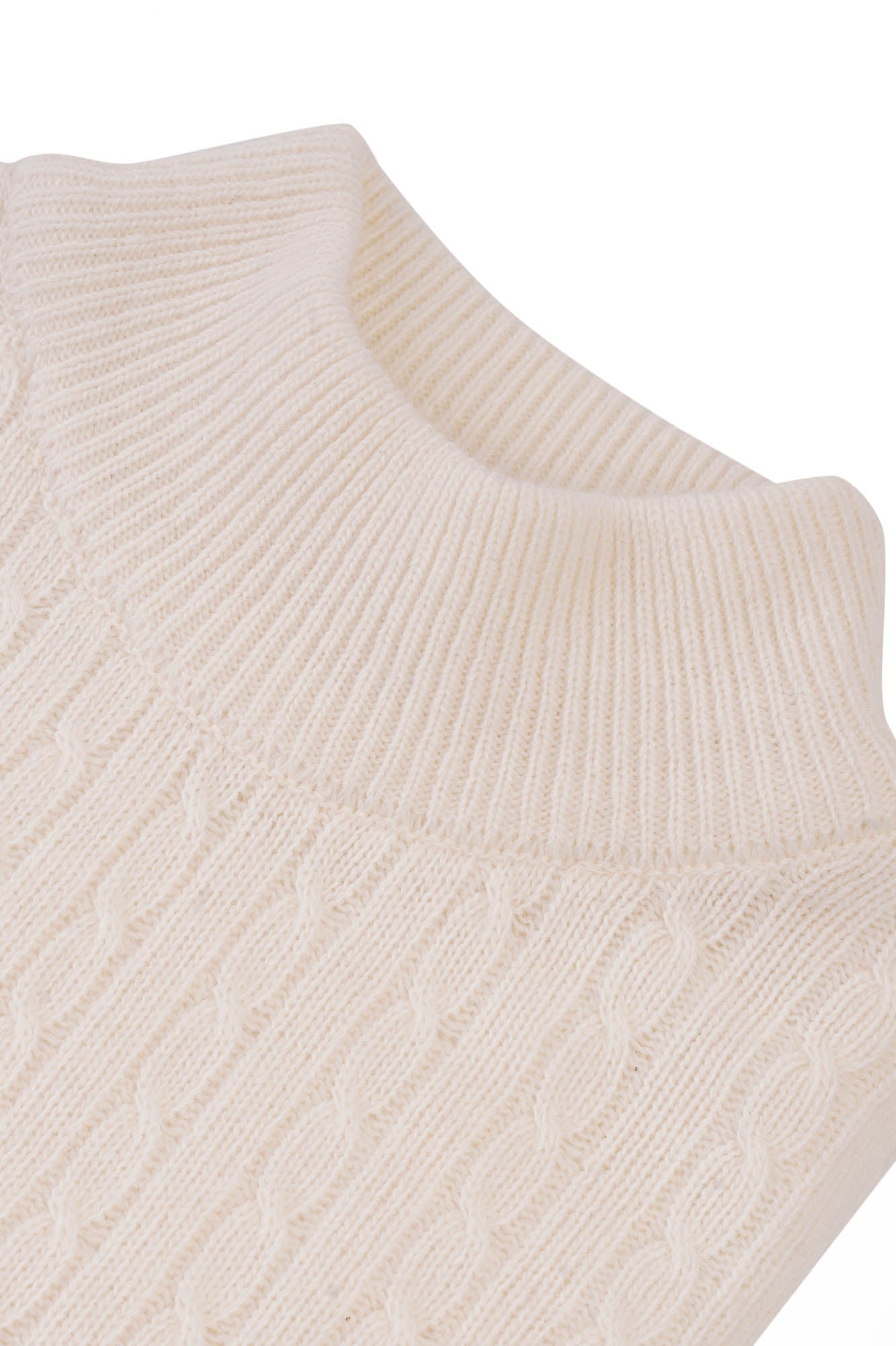 Image of Close-up of a beige knitted sleeveless sweater on a white background