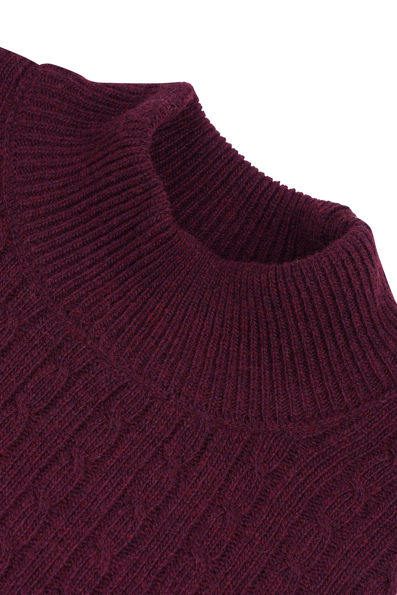 Image of Close-up of a maroon sweater with a ribbed texture on a white background
