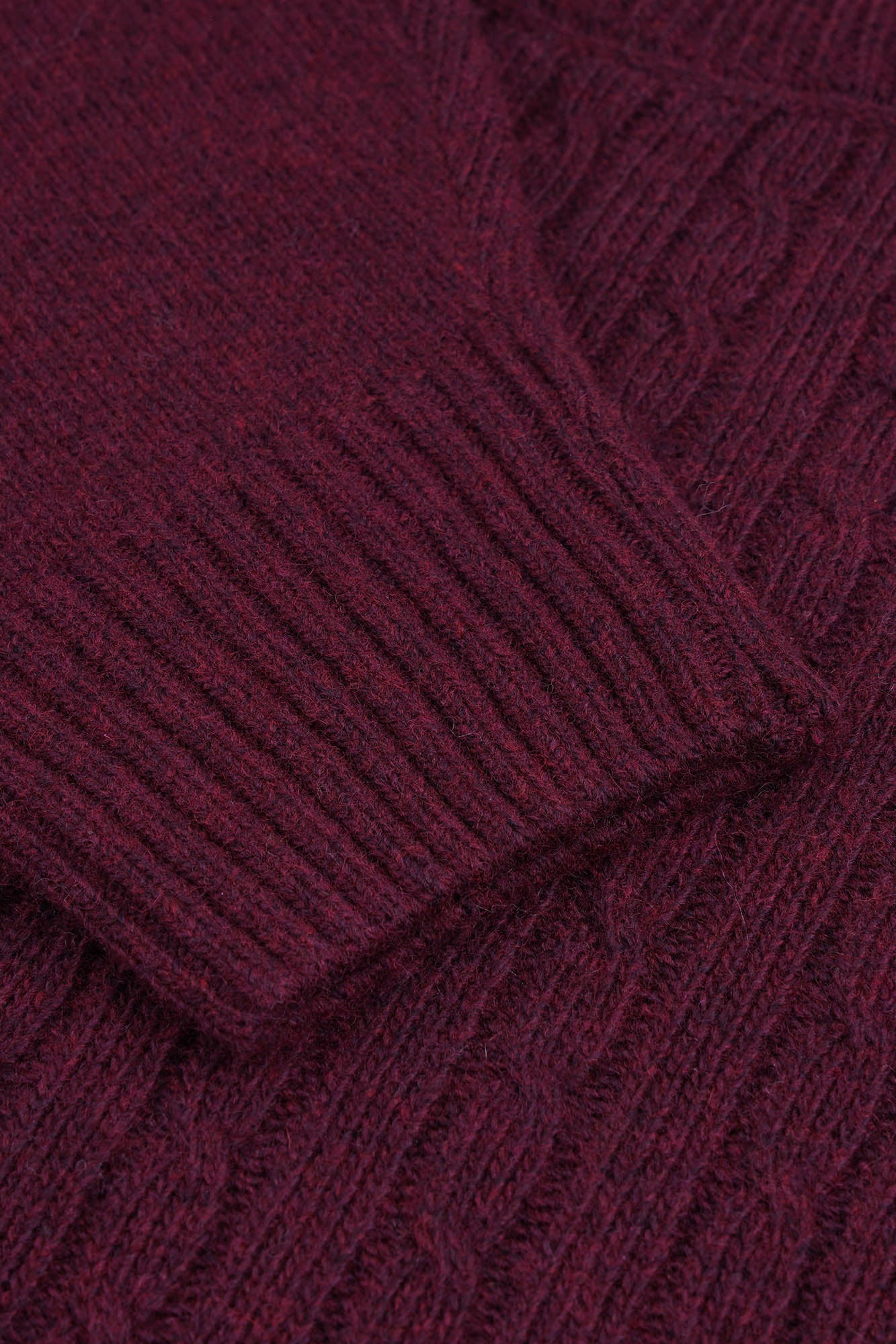 Image of Close-up of a burgundy knitted fabric texture