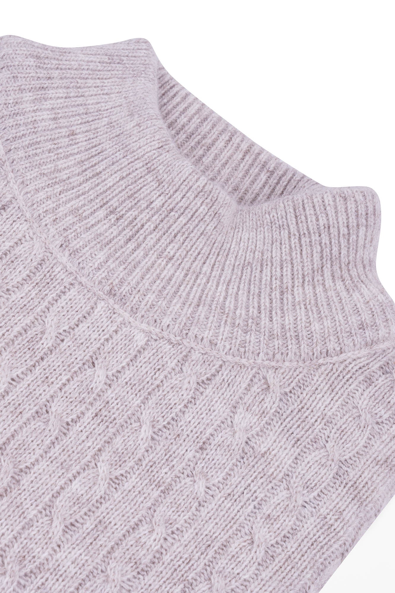 Image of Close-up of a light gray knitted sweater with cable pattern on a white background
