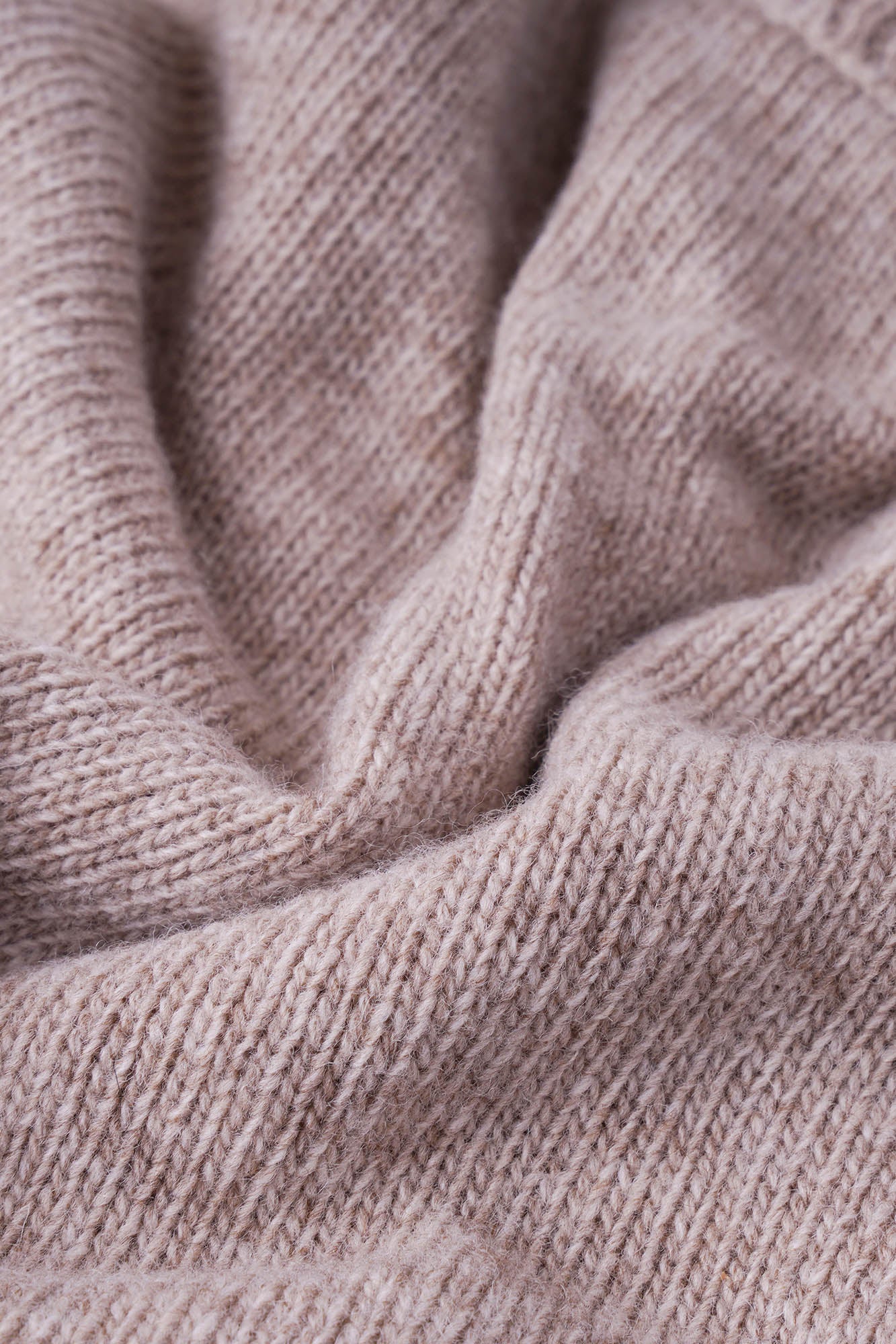 Image of Close-up of beige knitted fabric texture